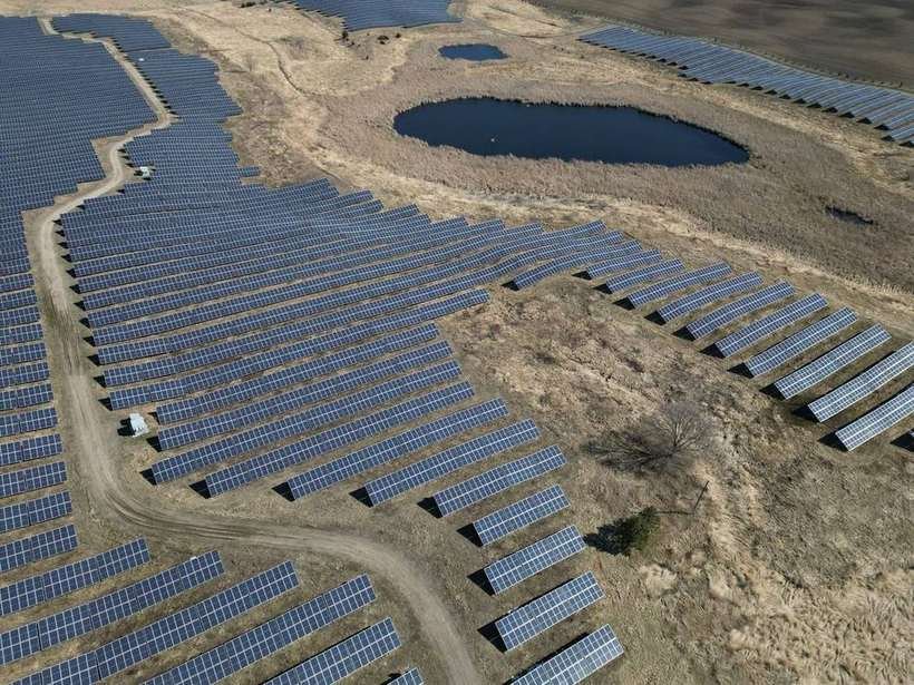 aerial view of a ground-mounted solar array showing row spacing and tilt angles